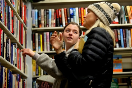Celeste Rooney, right, and her daughter Etain search the shelves of the Friends Book Shop at the Central Library in Virginia Beach. STEPHEN M. KATZ/STAFF photos